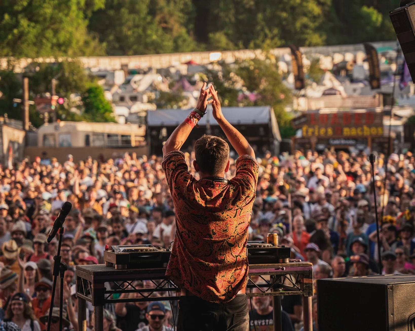 DJ Chris Arnold clapping to the crowd at Glastonbury Festival 2024